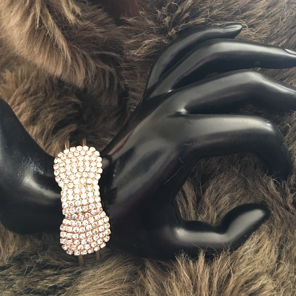 Rhinestone “bow” gold tone cuff bracelet